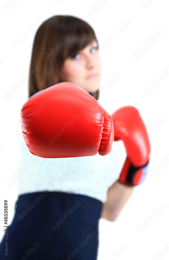 Young Business woman showing boxing glove to the camera Young Business woman showing boxing glove to the camera