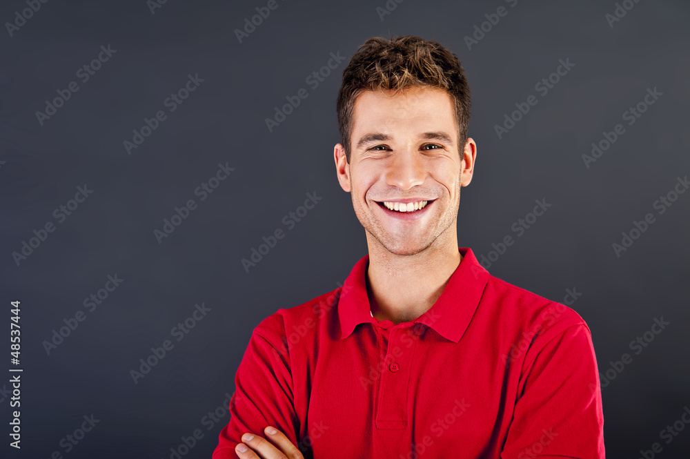 Man on black background in red shirt with smile Man on black background in red shirt with smile