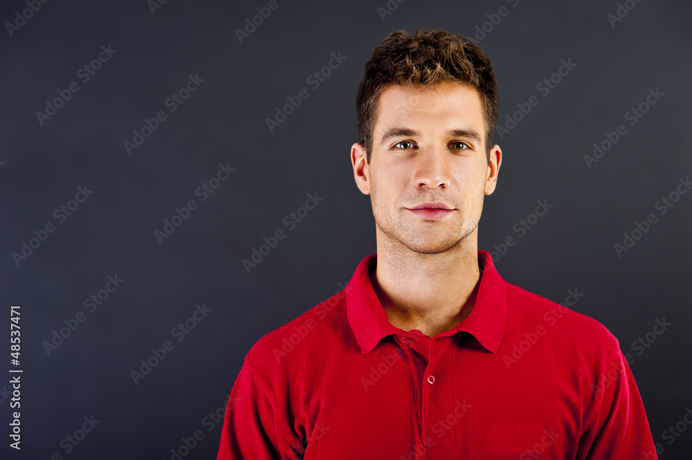 Man on black background in red shirt with smile Man on black background in red shirt with smile
