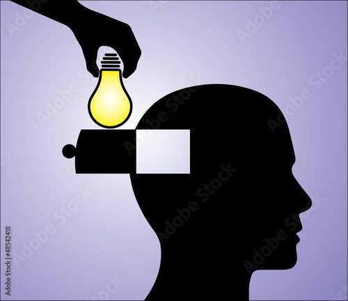 A hand inserting a glowing light bulb into a man's head