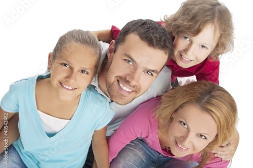 portrait of a family looking up and smiling happily