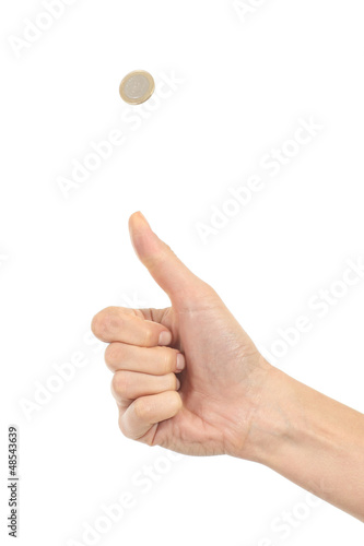 Fotografie Woman hand tossing a coin