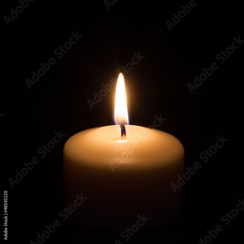 Candle on black background