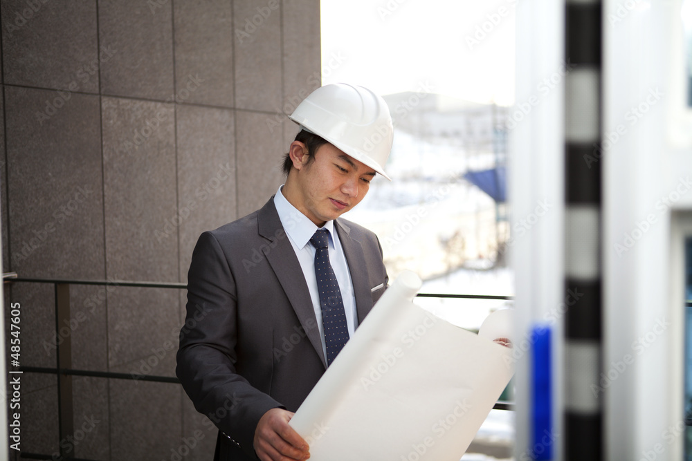 handsome architect checking plan handsome architect checking plan