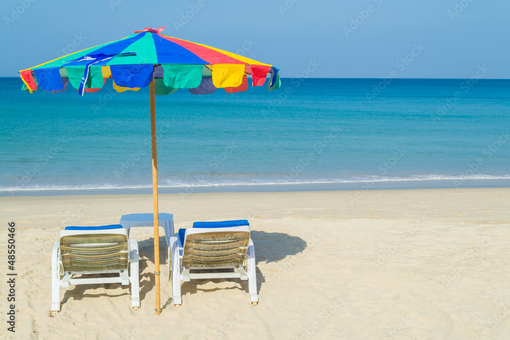 colourful beach umbrella and deck chairs on the beach