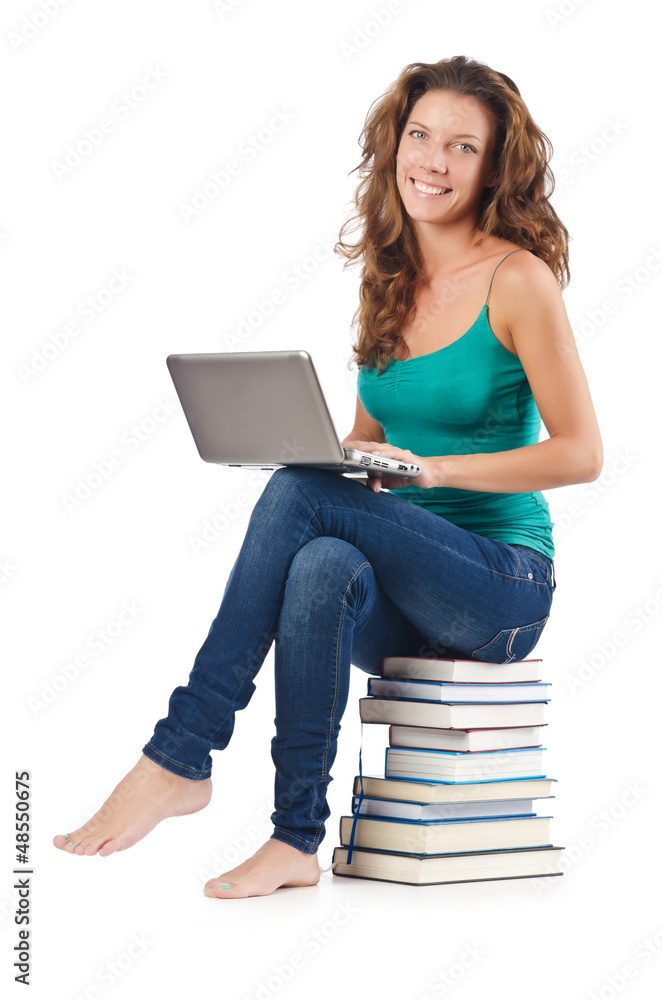 Student with netbook sitting on books Student with netbook sitting on books