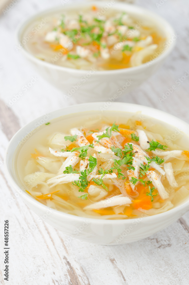 two bowls of vegetable soup with chicken and parsley two bowls of vegetable soup with chicken and parsley