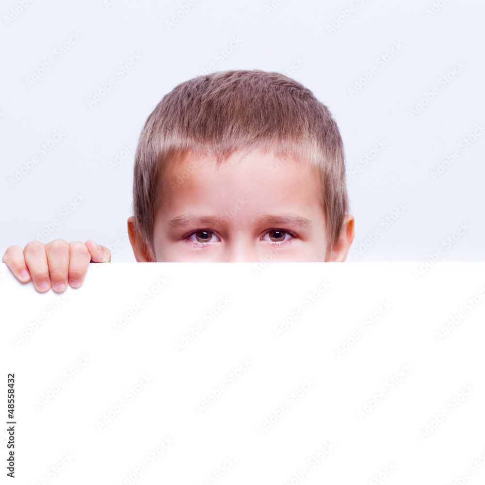 cute child behind a white board isolated cute child behind a white board isolated