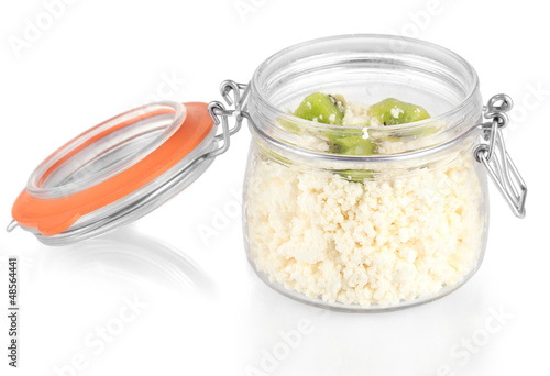 Cottage cheese in glass bottle with kiwi fruit, isolated