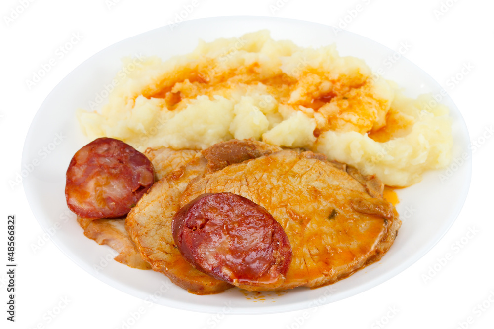 meat with sausage and potato on the plate on white background