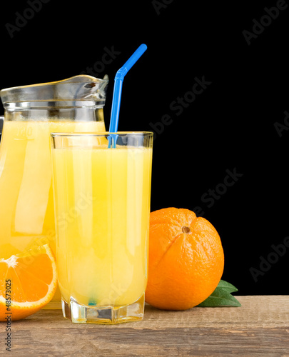 orange juice in glass and jug