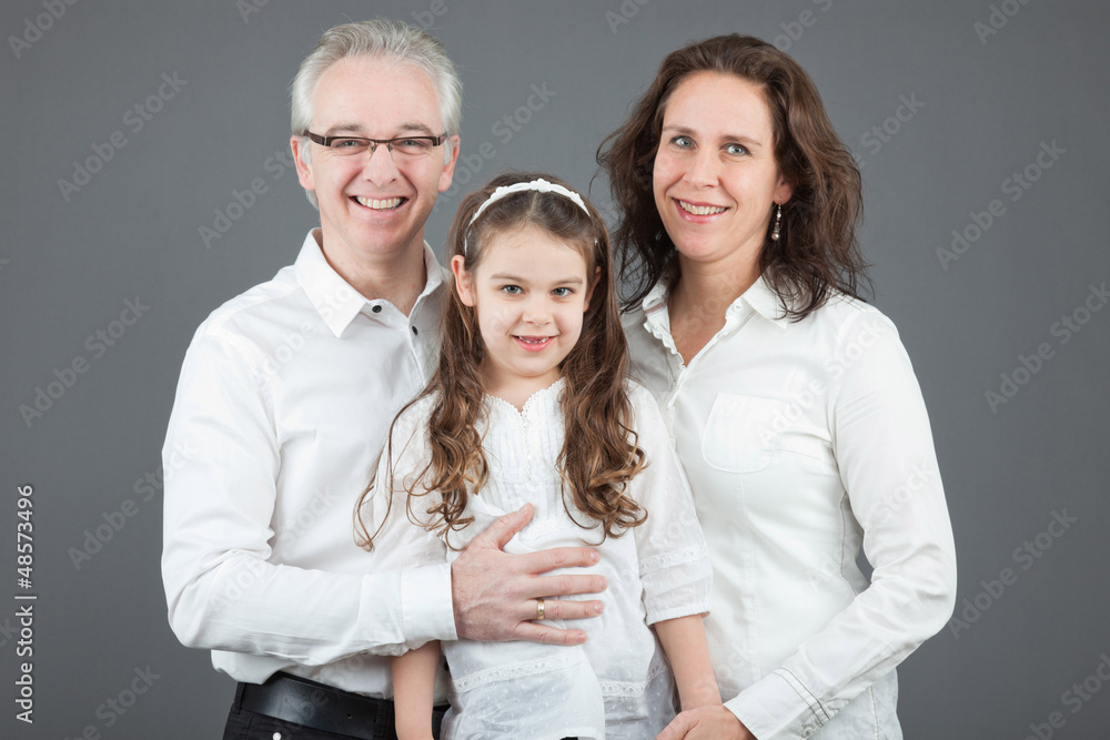 Happy family of father, mother and daughter. Studio shot. Happy family of father, mother and daughter. Studio shot.