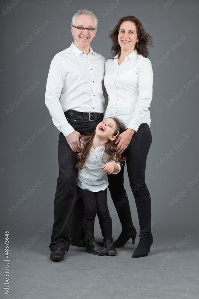 Happy family of father, mother and daughter. Studio shot. Happy family of father, mother and daughter. Studio shot.