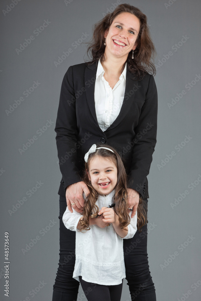 Happy mother with young daughter. Studio shot. Happy mother with young daughter. Studio shot.