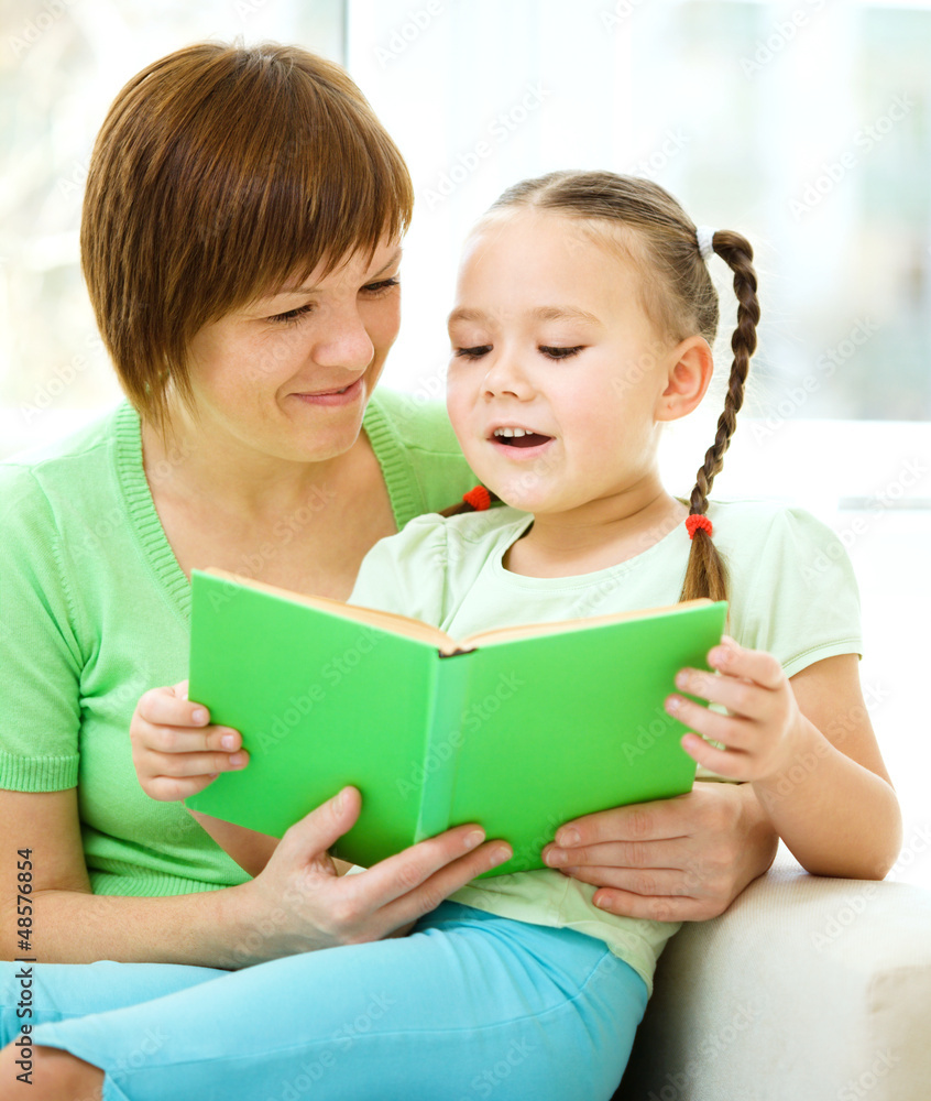 Mother is reading book with her daughter Mother is reading book with her daughter