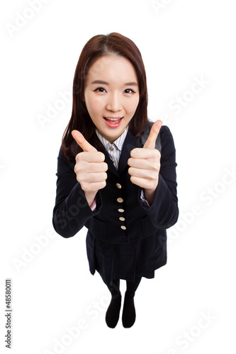 Young Asian student shwing thumbs isolated on white background.