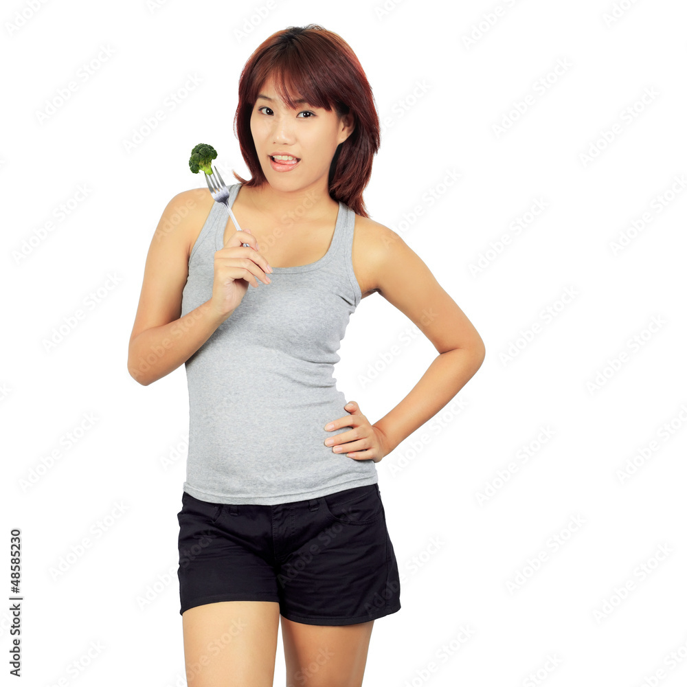 Isolated young asian woman with a picec of brocolli Isolated young asian woman with a picec of brocolli