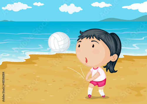 A girl playing ball on a beach