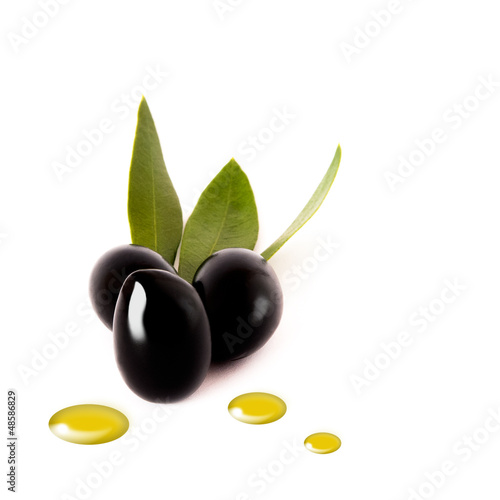 Black olives with oil drops on white