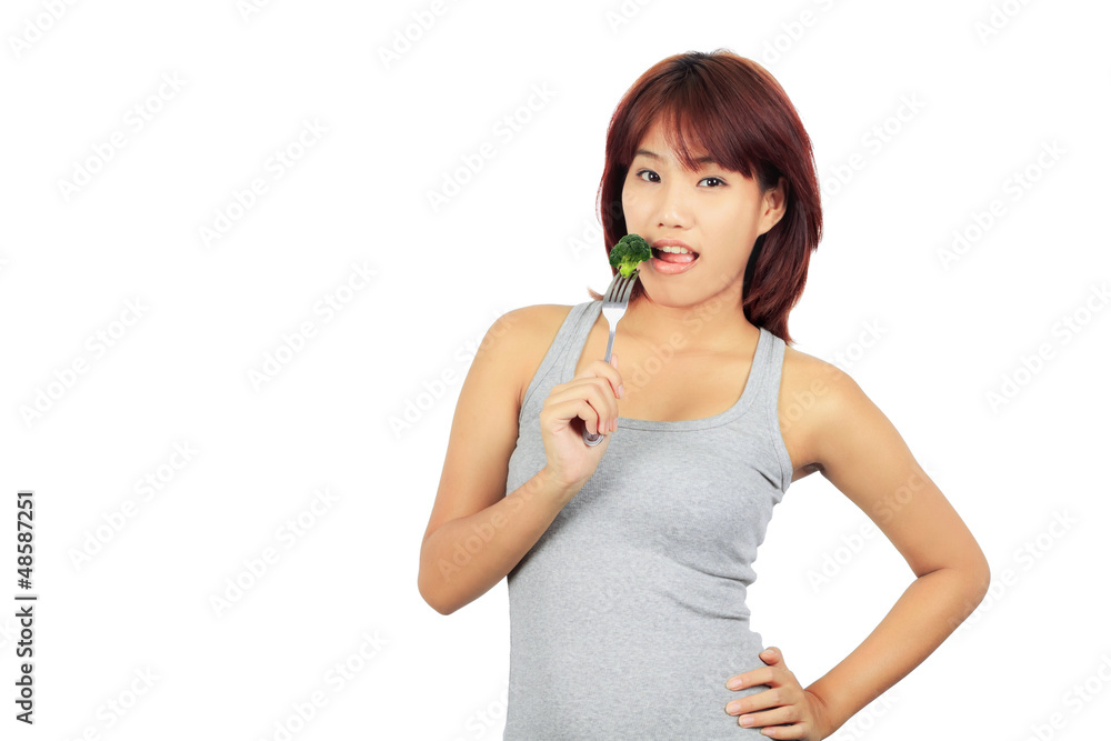 Isolated young asian woman with a picec of brocolli Isolated young asian woman with a picec of brocolli