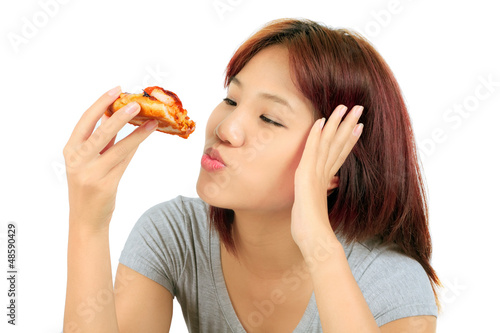 Isolated young asian woman with a piece of pizza