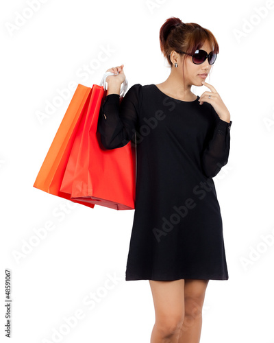 Isolated young asian woman carries shopping bags