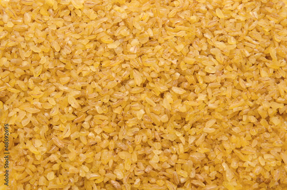 Bulgur wheat grains forming textured background Bulgur wheat grains forming textured background