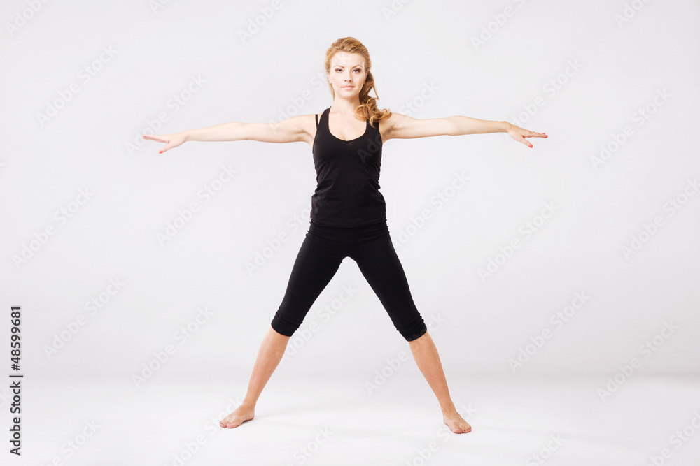 Sporty woman doing stretching exercise Sporty woman doing stretching exercise