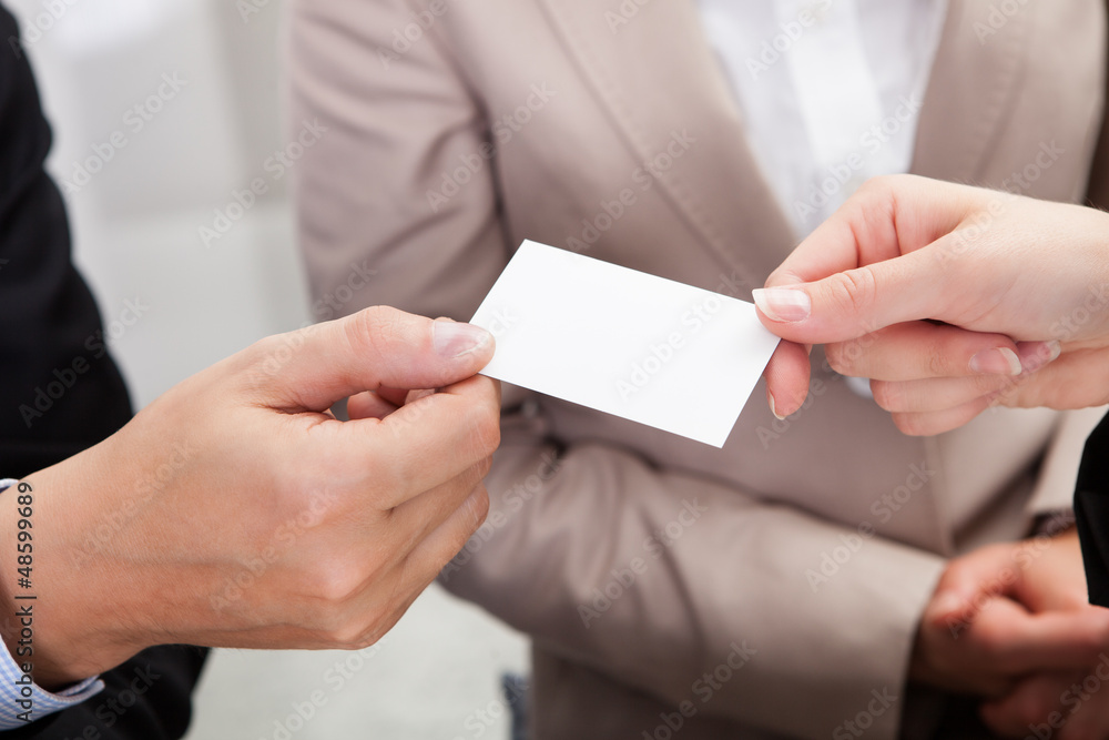 Fototapeta premium Businesspeople exchanging cards over coffee