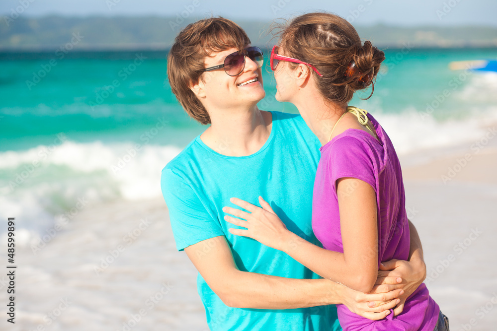 young happy couple having fun on tropical beach. honeymoon young happy couple having fun on tropical beach. honeymoon