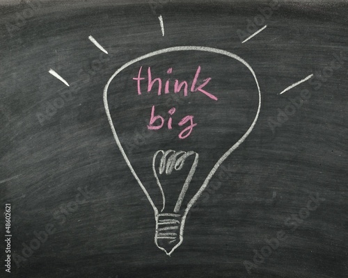 the word think big and light bulb drawn on a chalk board