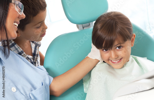 little girl with brother in dentist office