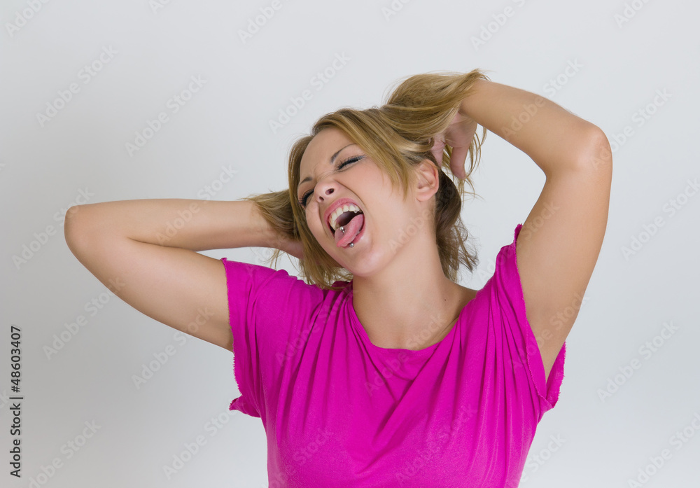 Fototapeta premium Close up of young woman making funny faces