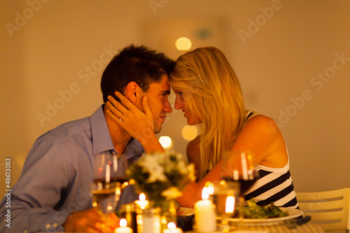 young loving couple having romantic dinner together photo