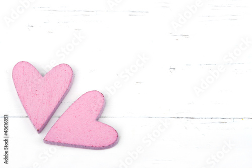 Two pink hearts on white background