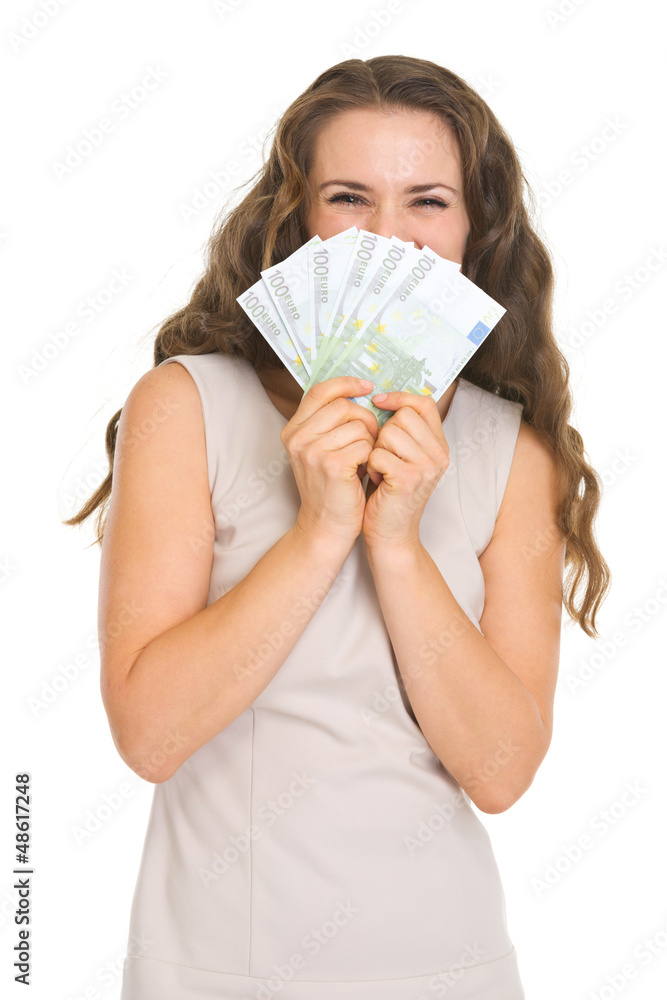 Happy young woman hiding behind fan of euros Happy young woman hiding behind fan of euros