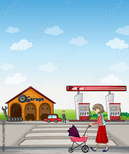A mother walking along a garage and gasoline station