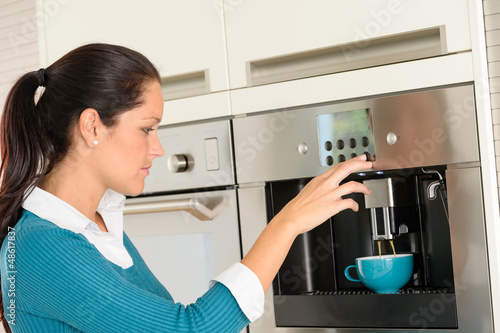 Happy woman making coffee machine kitchen cup