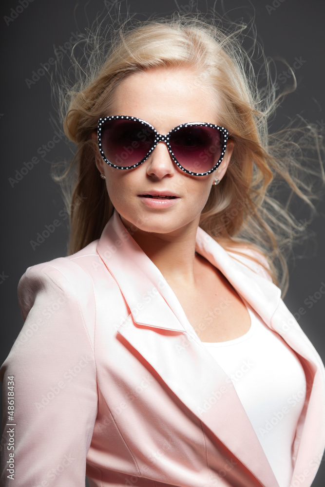 Blonde girl with long hair and sunglasses. Beauty studio shot. Blonde girl with long hair and sunglasses. Beauty studio shot.