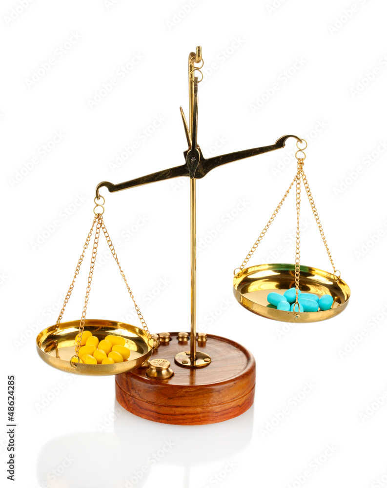 Classic scales with color pills isolated on white Classic scales with color pills isolated on white
