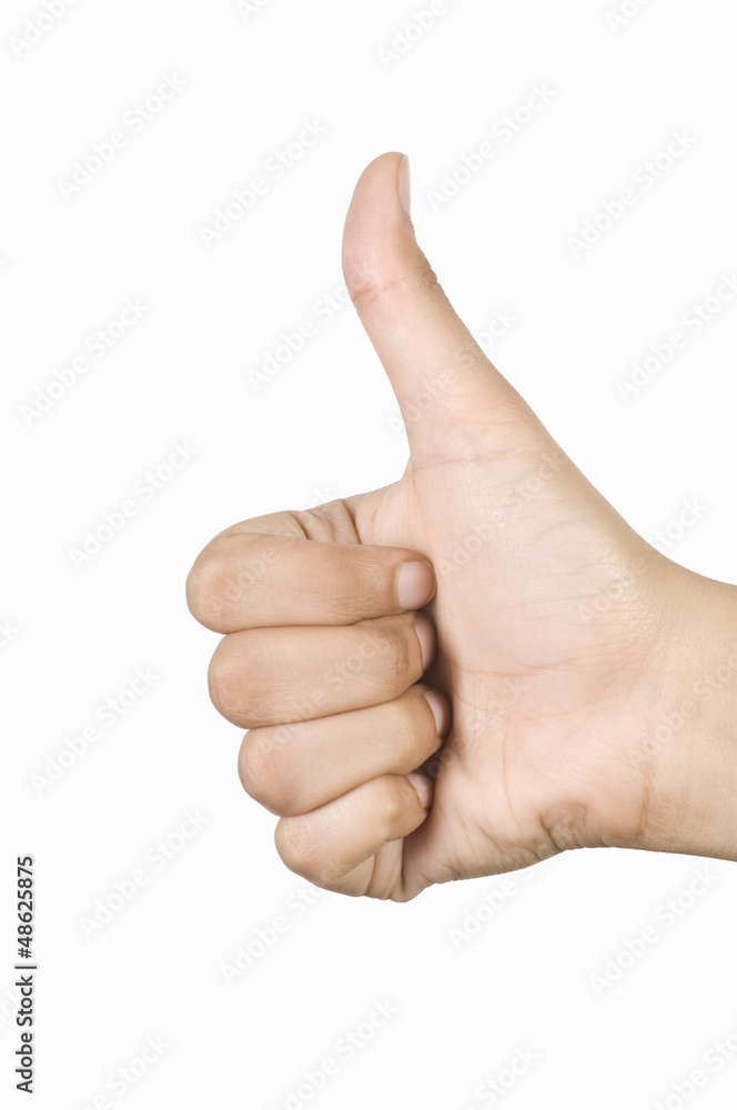 Close-up of a person's hand making the thumbs up sign Close-up of a person's hand making the thumbs up sign