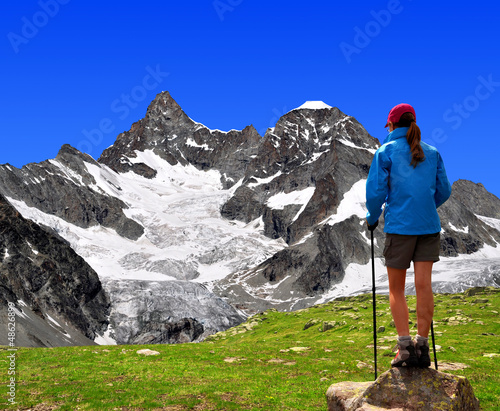 girl looking at the  Mount Gabelhorn in the Swiss Alps photo