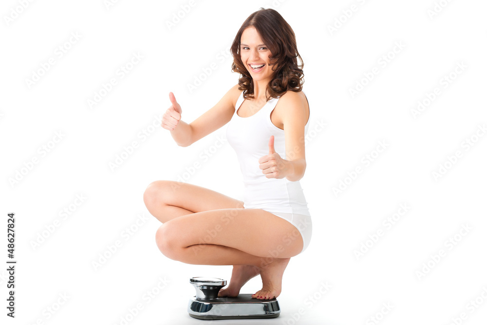 Young woman sitting on her haunches on a scale Young woman sitting on her haunches on a scale