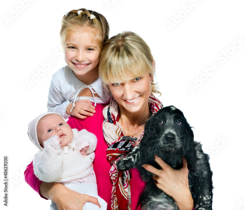 Pretty young woman with her daughters and dog