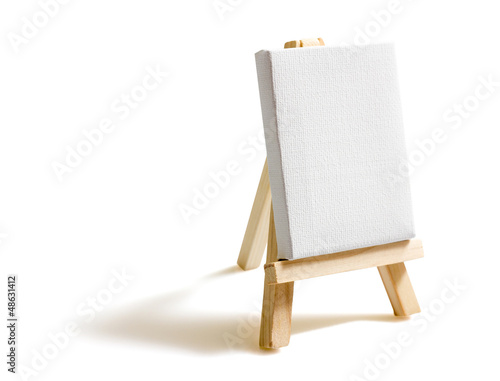 Blank canvas on easel isolated on white background