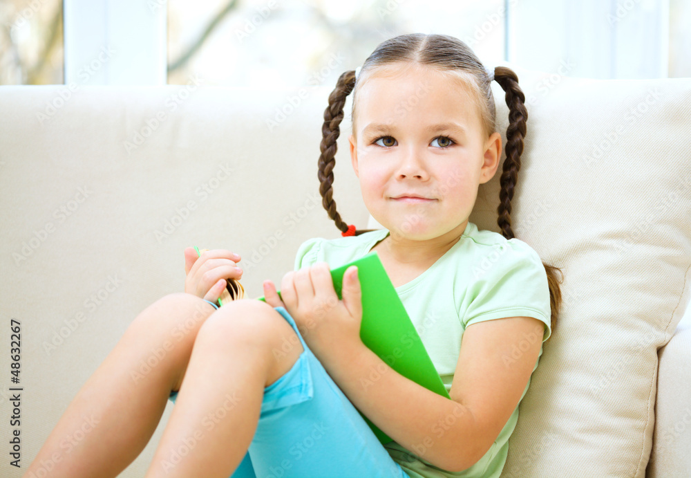 Little girl reads a book Little girl reads a book