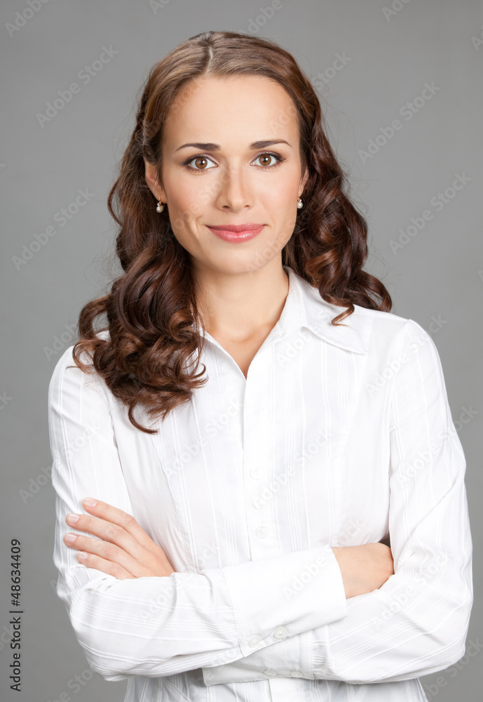 Smiling businesswoman, over gray Smiling businesswoman, over gray
