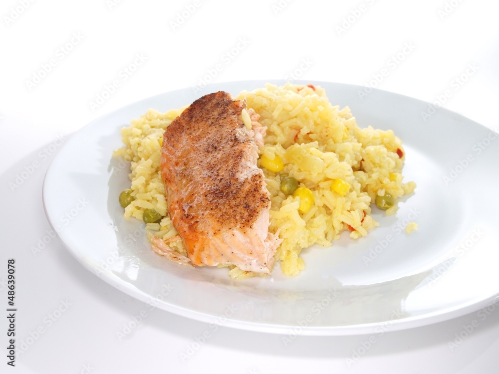 Grilled salmon fish piece, on a plate towards white
