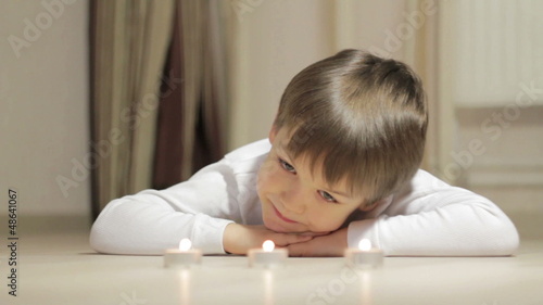 little boy looking at the candles photo