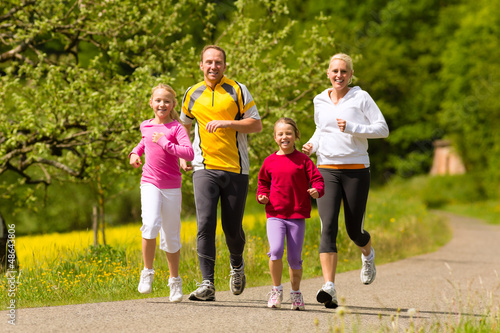Fototapeta Naklejka Na Ścianę i Meble -  Family running in the meadow for sport